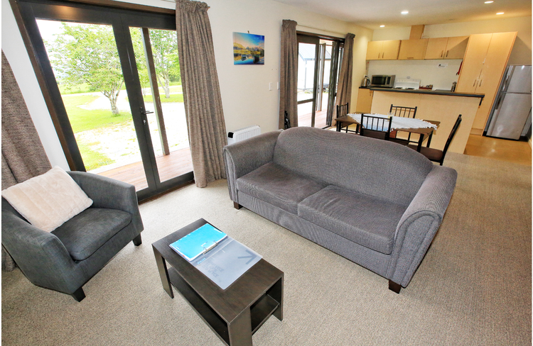 Living room of 2 bedroom cottage. Bedding of 2 bedroom cottage is 1 queen bed plus 2 single beds.