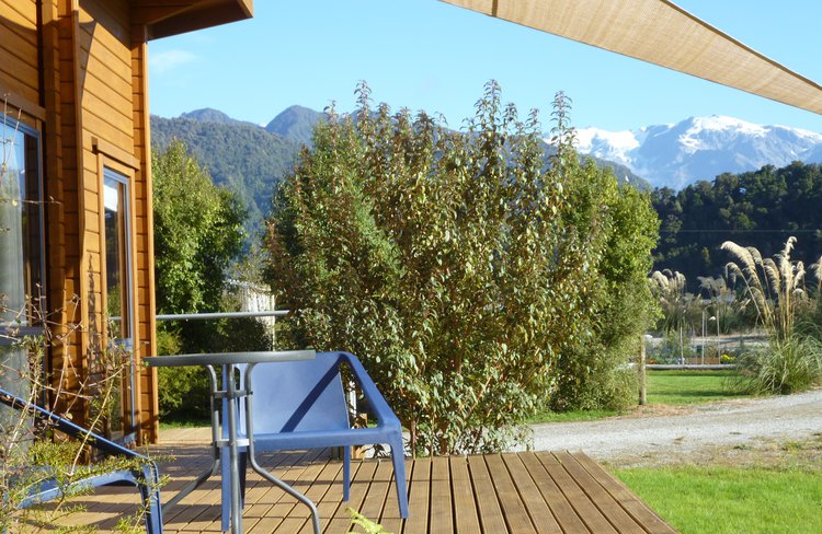 Enjoy views of the mountains from the deck of our private garden cottage.