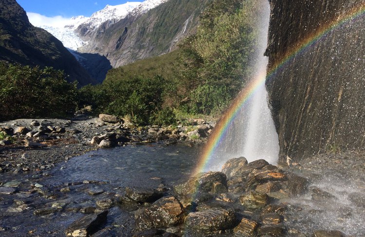 Rainbows in Trident Falls waterfall in the Franz Josef Glacier Valley