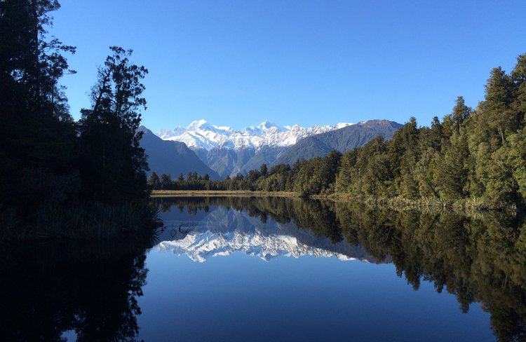 Iconic mirror-like reflections at Lake Matheson, West Coast NZ