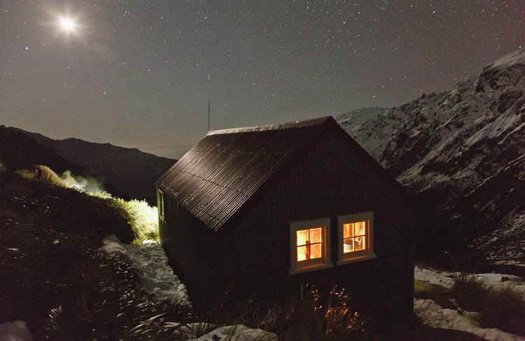 On a clear evening, enjoy the mountains to sea vista and crystal clear air while inside the historic hut is bathed in candlelight.